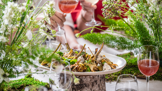 Sharing-food-vegetables-cheese-meal-glasses-in-the-background